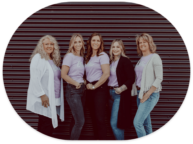 Five smiling female dental team members