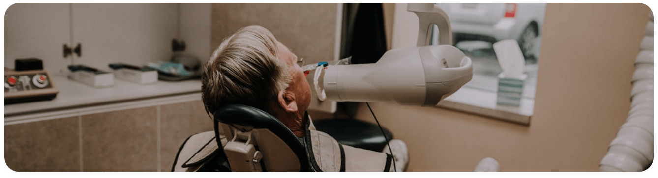 Man sitting patiently in dental chair while visiting Washington cosmetic dentist