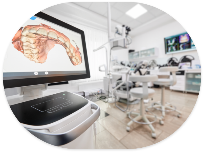Digital model of teeth on computer monitor with dental treatment room in background