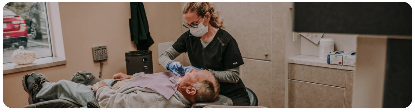 Dentist treating a patient by replacing missing teeth in Washington