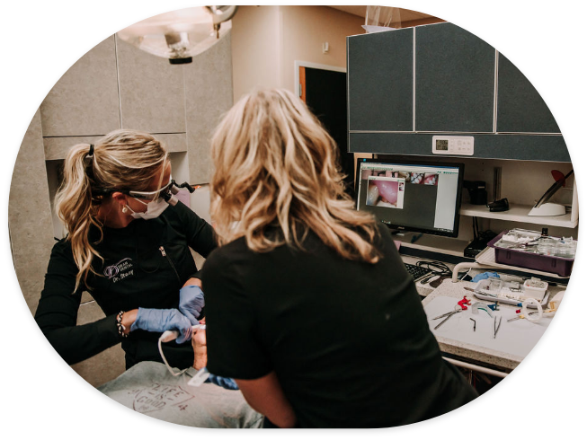 Dentist and assistant treating a dental patient