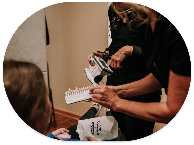 Cosmetic dentist showing veneers to a patient