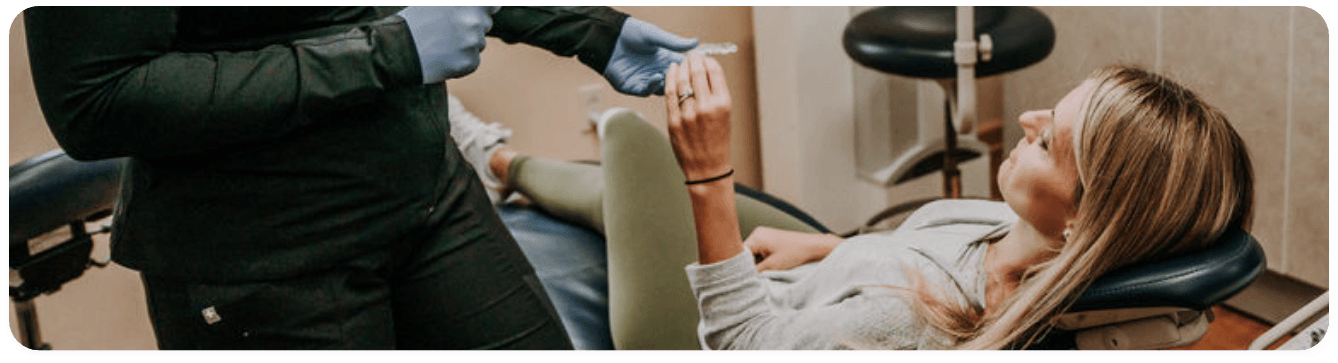 Woman in dental chair receiving dental services in Washington