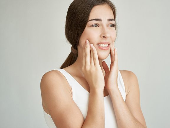 Young woman with jaw pain