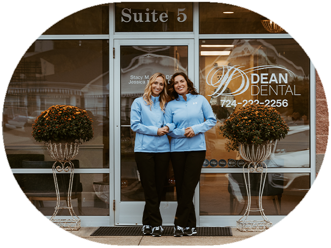 Two Dean Dental team members on computers at front desk