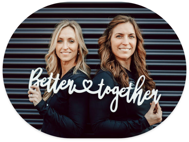 Doctor Stacy Dean and Doctor Jessica Dean holding sign that reads Better Together