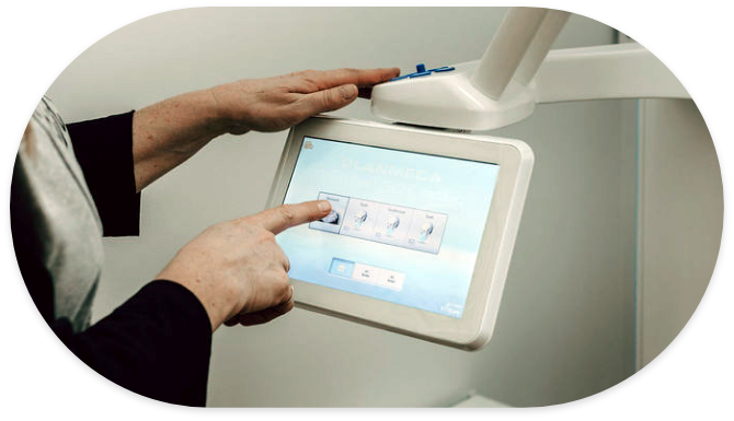 Dental team member touching screen on dental scanning device