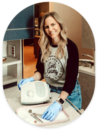 Doctor Stacy next to tray with dental instruments