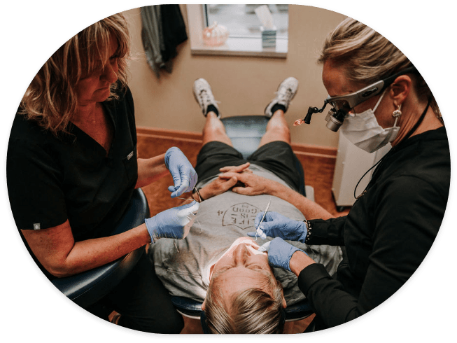 Dentist and assistant performing a dental checkup