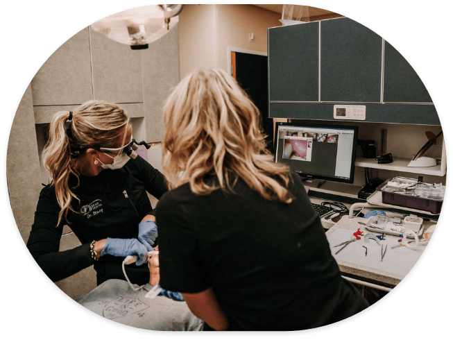 Dentist performing an oral cancer screening on a patient