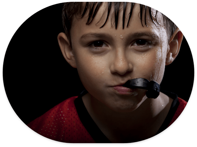 Young boy with black athletic mouthguard