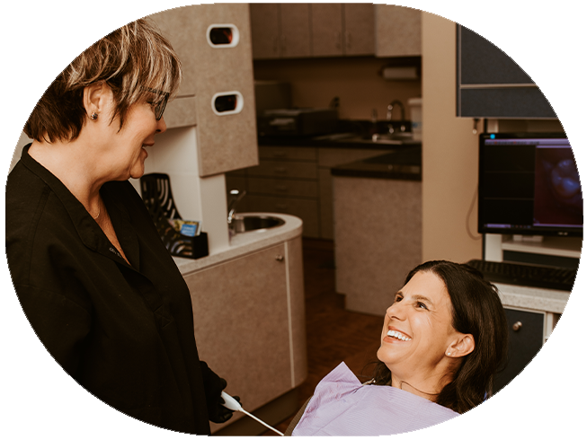 Woman smiling at her dentist during dental checkup