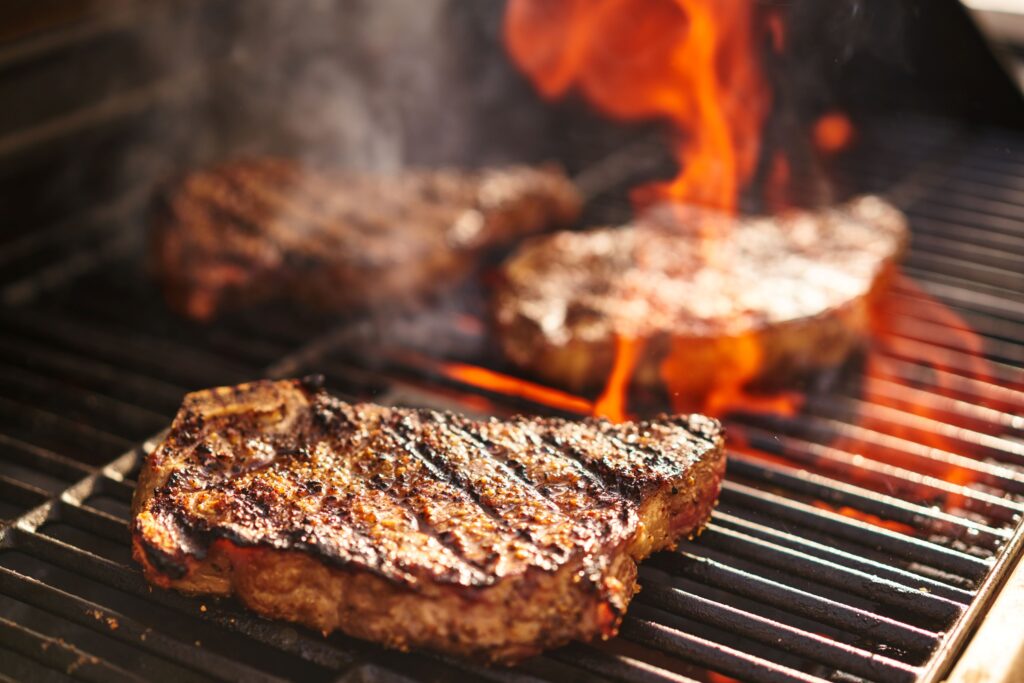 Closeup of steaks on a fired up grill